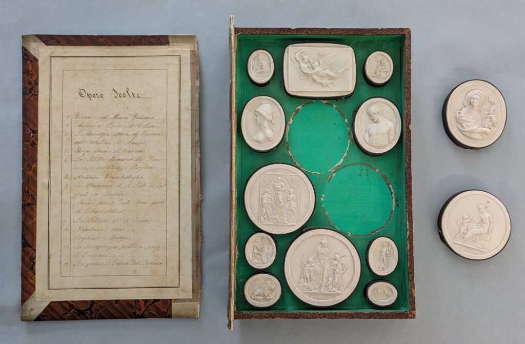 The image depicts one of Giovanni Liberotti Impronte Books, the cover is lose and some og the medallions are lose too